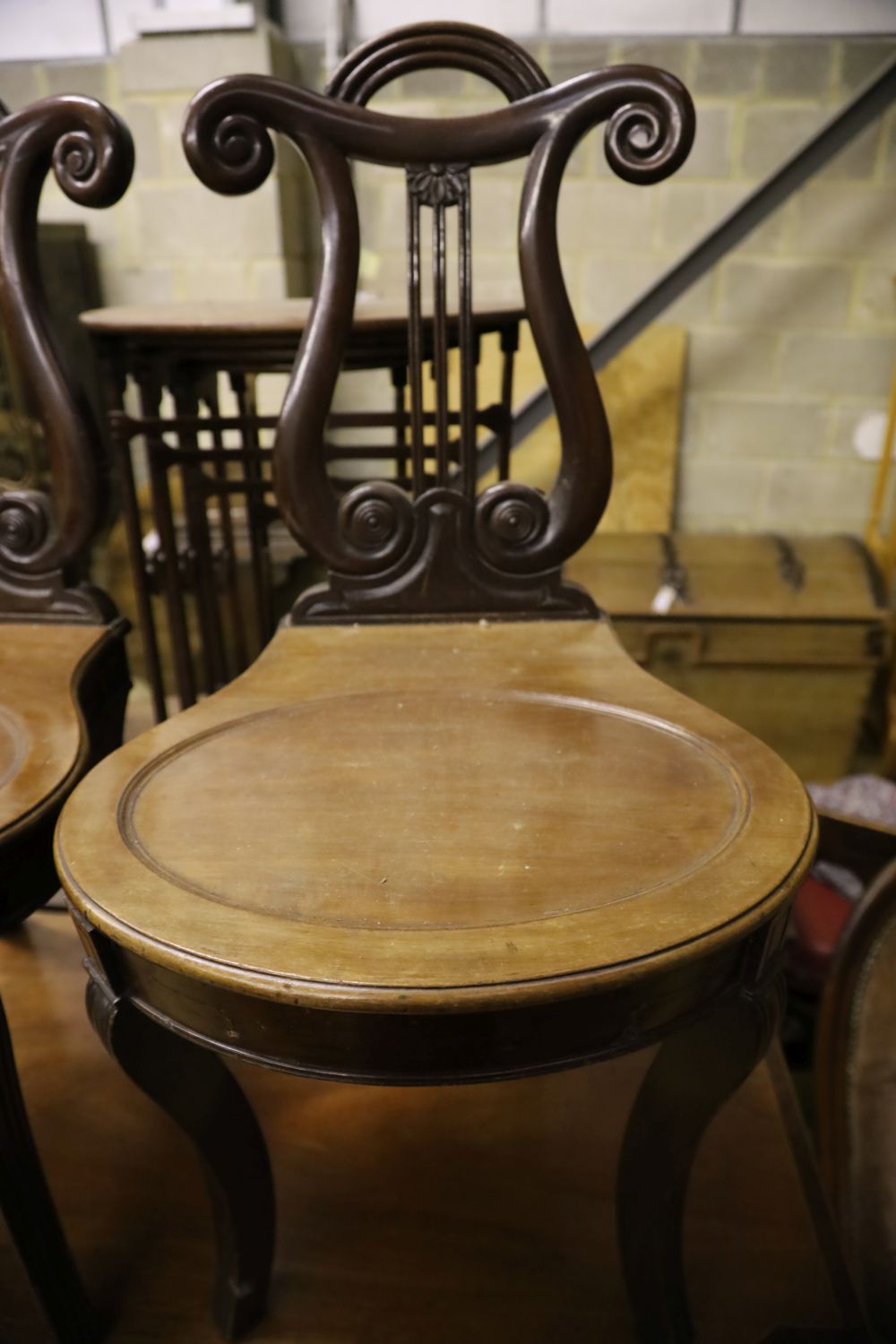 A pair of George IV style mahogany hall chairs